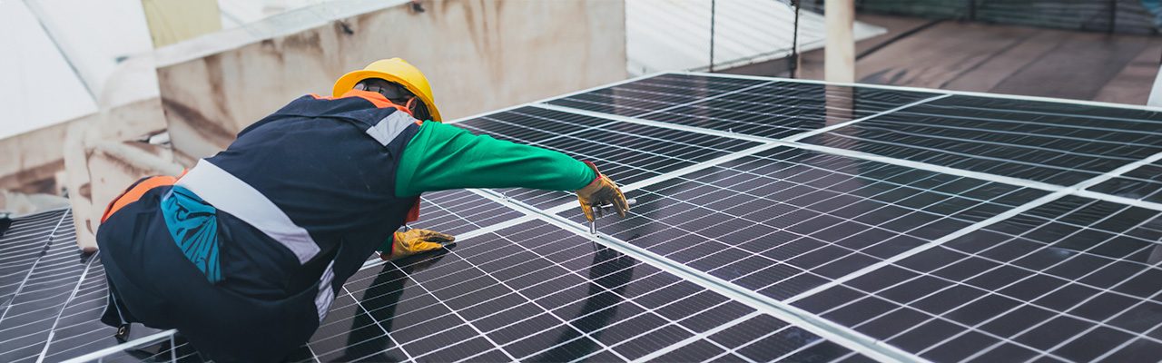 man-working-on-solar-panels