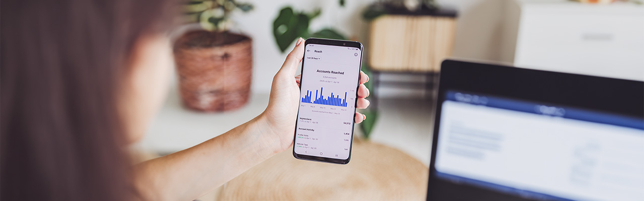 hand-holding-phone-social-media-analytics