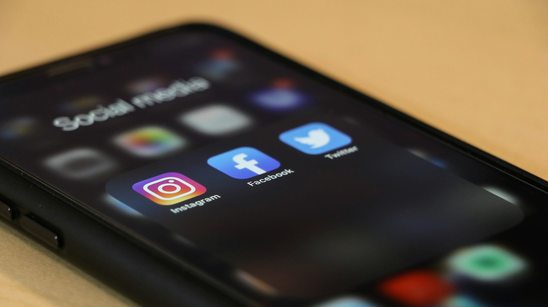 Hand holding phone displaying a poll overlay on a social media feed