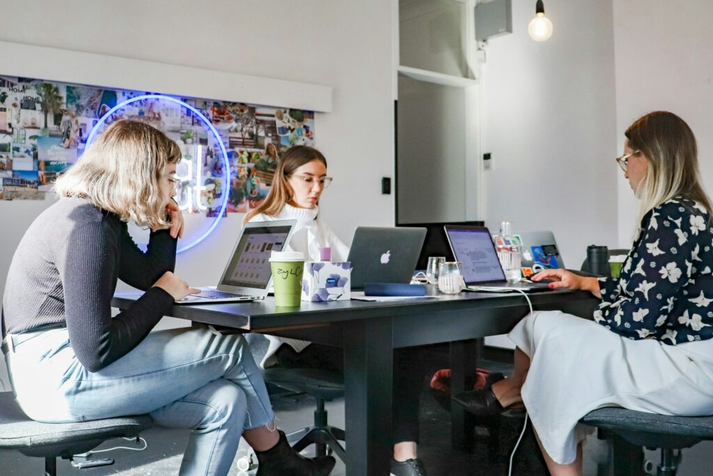 Young woman managing social media content from her workspace, representing modern brand identity building.